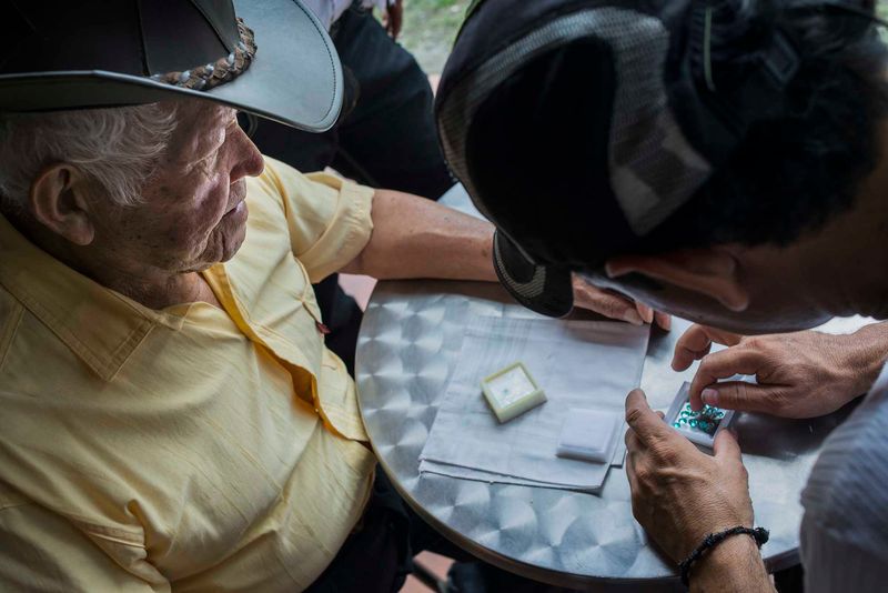 © Javier Corso - Miners, barequeros, merchants and tourists make deals everyday in the market of Muzo in search of the best emeralds.