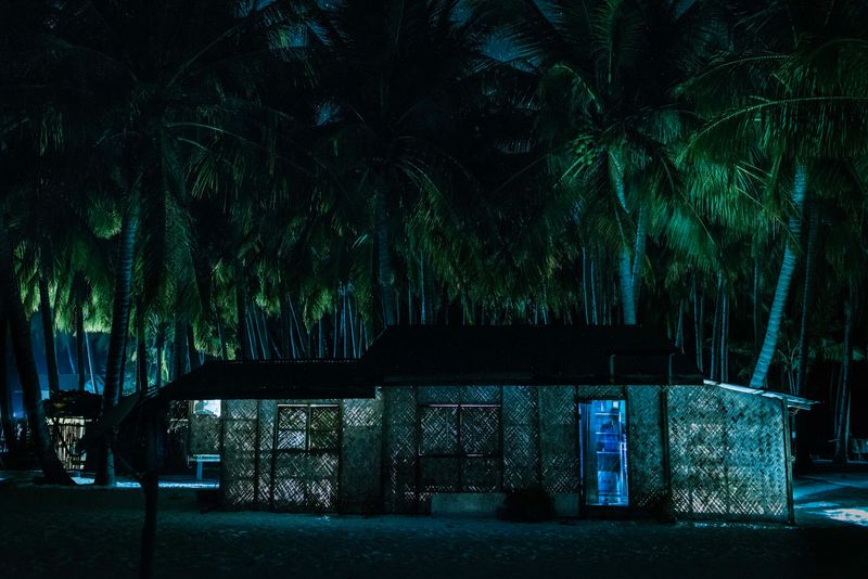 © Katherine Jack - A man stands in the doorway of his solar-powered home in Daracoton village. Palawan, 2017