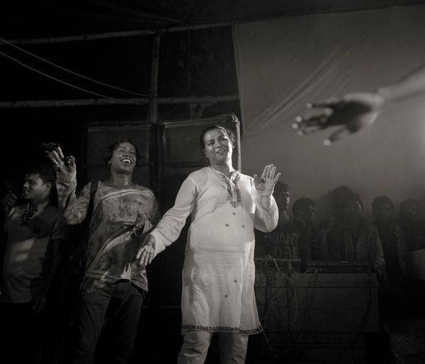 © Shahria Sharmin - Pinky Guru (56)R, leader of a Hijja community,dancing with her follower in a Puja Party. 