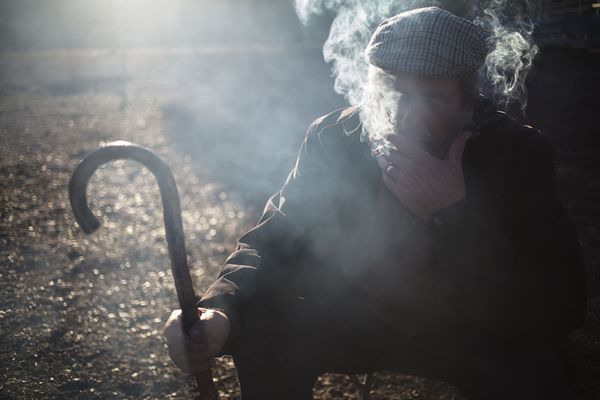 © Susana Giron - Antonio Alarcon, nomad shepherd, smoking a cigarette at early morning during the trashumant migration in Andalucia.