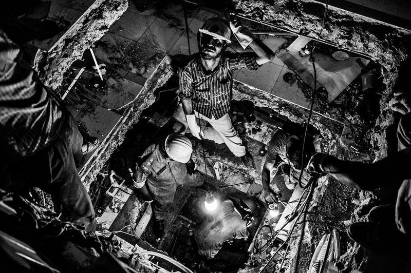 © Rahul Talukder - Rescue workers dug tunnels through the collapsed floors attempting to find survivors.