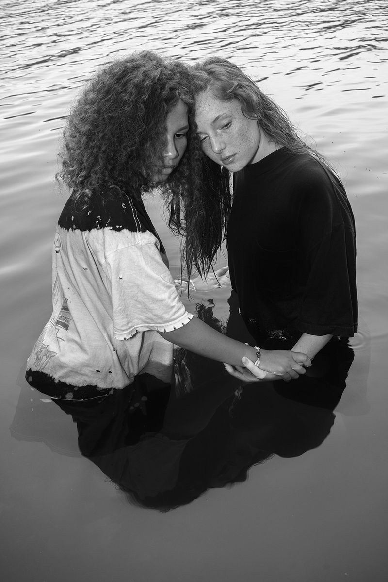 © Jillian Freyer - Aiyanna and Elizabeth embrace one another in the river