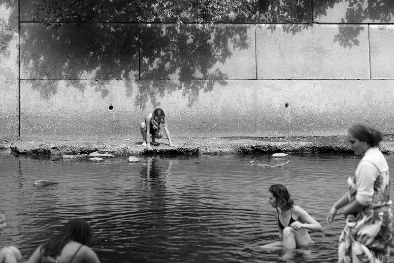 © Jillian Freyer - A girl along the river looks at her reflection, in isolation from the others.