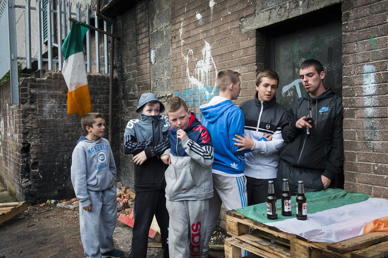 © Marika Dee - Surrounded by Irish flags, teenagers hang out in the Catholic New Lodge area of north Belfast.