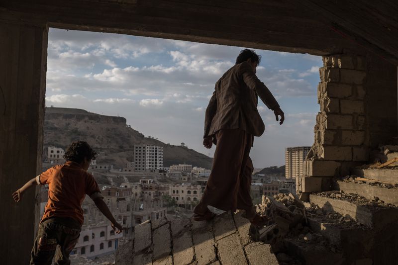 © Alex Potter - Yemeni brothers climb the stairs of a damaged building on the outskirts of Sana'a.