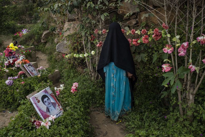 © Alex Potter - A girl visits the graves of Houthi martyrs killed in previous wars against them.