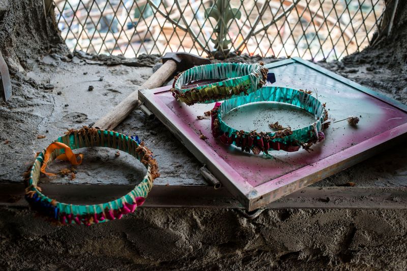 © Alex Potter - Crowns worn by wedding-goers sit in the window of a building that was damaged when the celebration was hit by an airstrike.