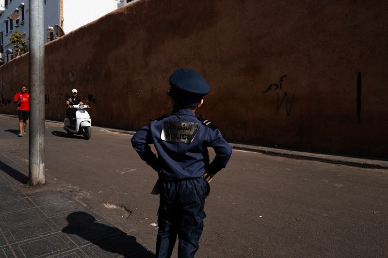 © Jacopo Da Col - A child in a police costume plays with people passing by.