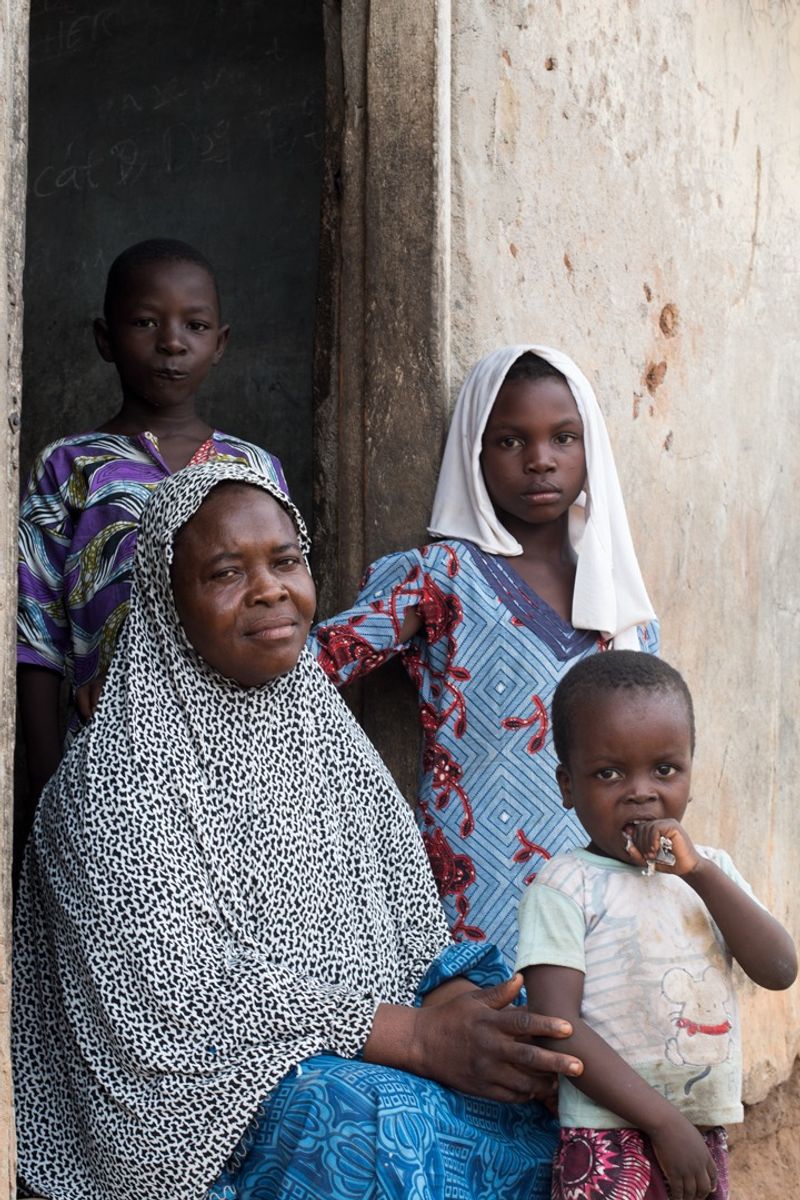 © Igho Ogbobine - Halimata and her children after the close of the day’s work.