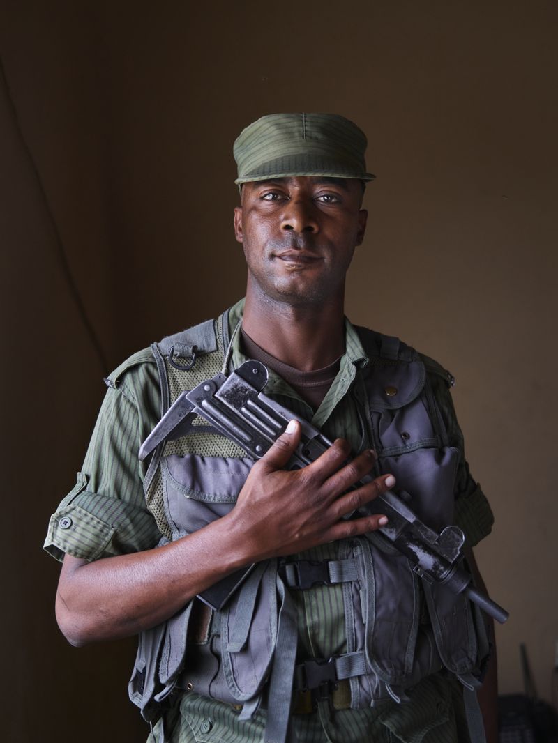 © Jörg Gläscher - Police officer Habukali Mainza, has a second job working in a private shift securing a large rice mill, Lusaka, Zambia