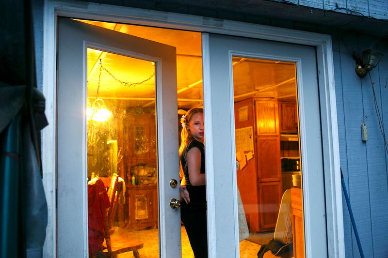 © Maddie Mcgarvey - Sonya peeks out through the door before entering her grandmother's home.