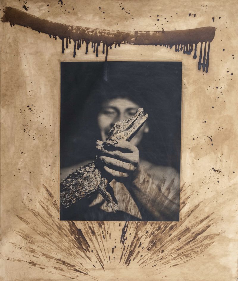 © Felipe Jacome - A young man inspects a small crocodile during a night stroll along the Río Cononaco.