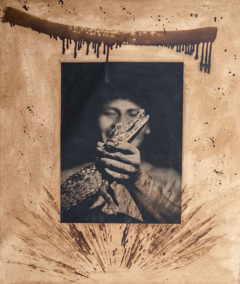 © Felipe Jacome - A young man inspects a small crocodile during a night stroll along the Río Cononaco.