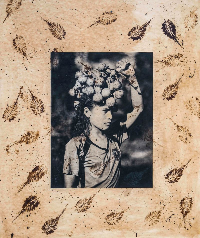 © Felipe Jacome - Isabel carries a bushel of chonta, a coveted fruit that grows on chonta palm trees only once a year.