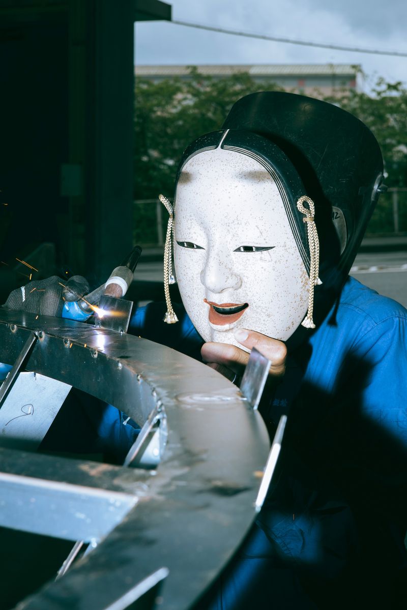 © Kenta Nakamura - When photographing the welding operation, we asked them to hold a Noh mask.