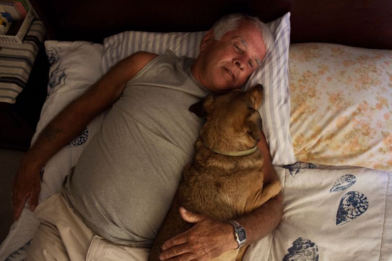 © Sofia Valiente - Gene laying down with his dog Killer. "Only a fool would truly trust anyone if you are a sex offender."