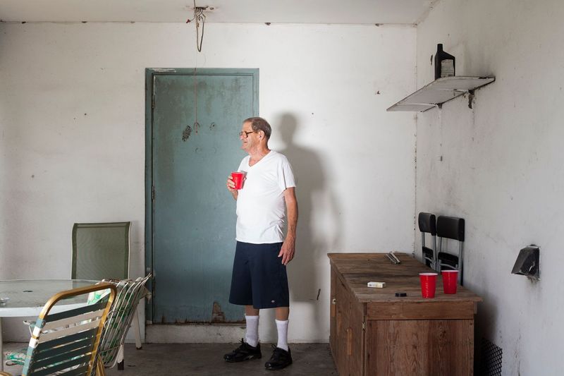 © Sofia Valiente - Paul standing outside on his porch.