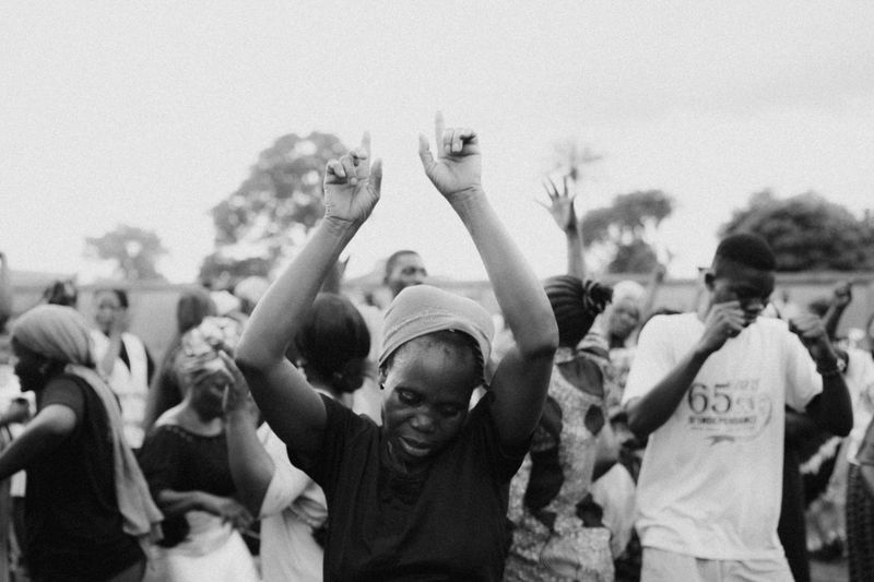 © Jeff Tidwell - A woman dances with a group during the nightly meetings