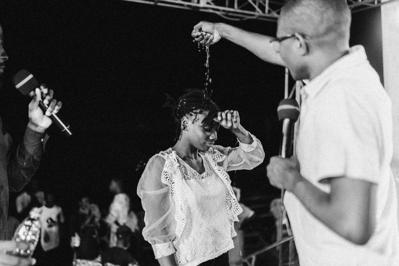 © Jeff Tidwell - A woman is baptized by a pastor at one of the nightly meetings.