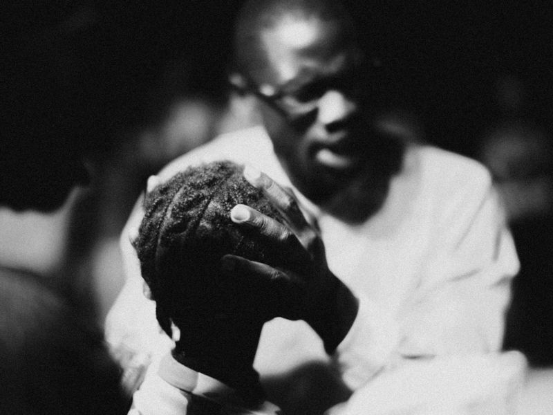 © Jeff Tidwell - A pastor prays for a young girl