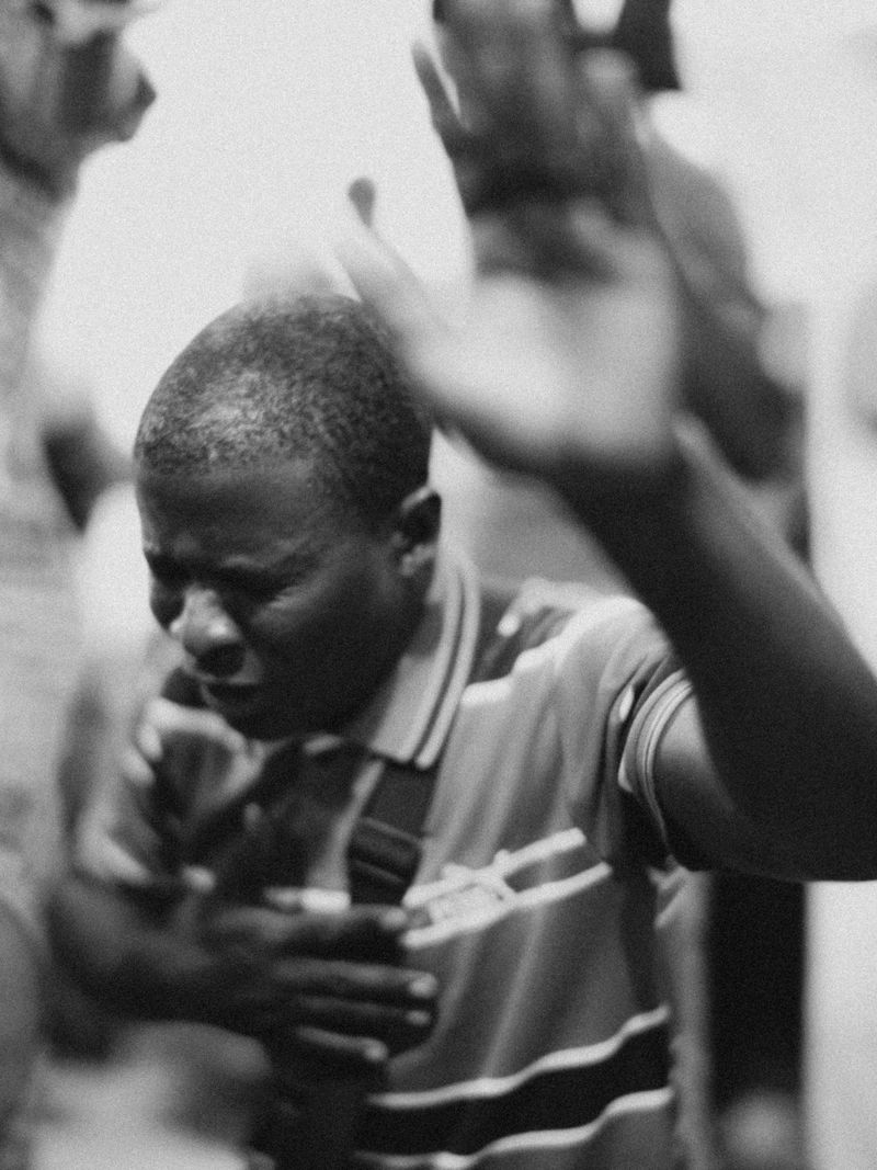 © Jeff Tidwell - A young man worships during a night service a the local church