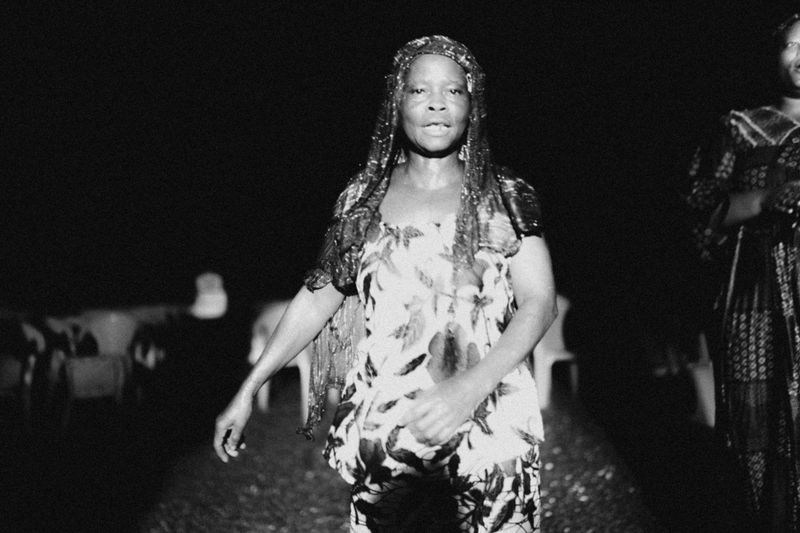 © Jeff Tidwell - A woman dancing in the rain at a nightly outreach