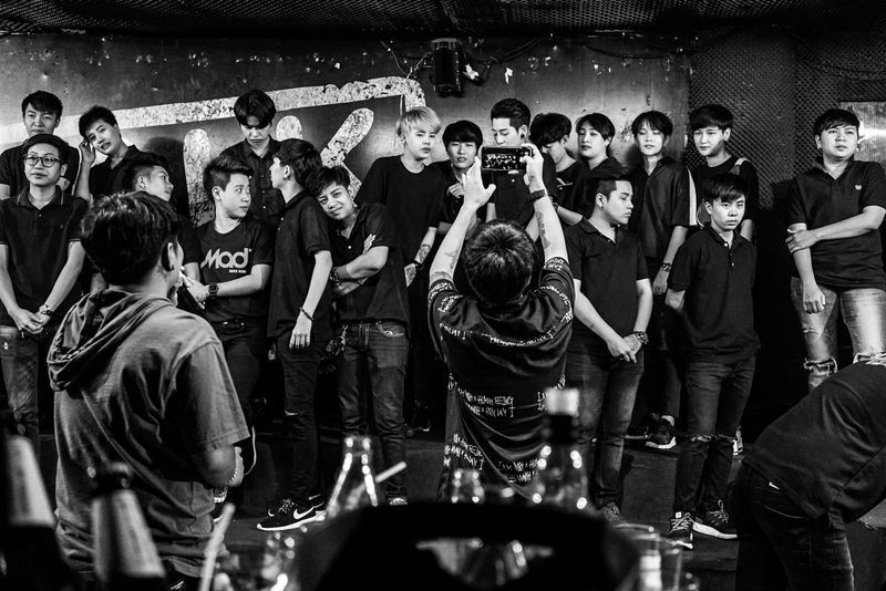 © JANUSZ DAGA - Toms parade in front of the customers. Just choose one to spend the night with. Talking and drinking.