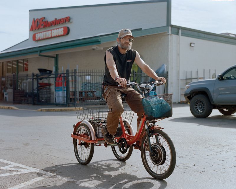 © Marco Waldis - A Forks resident on his homemade electric tricycle in the Outfitters parking lot.