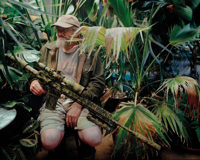 © Marco Waldis - Arm, the local gunsmith, poses inside of his tropical greenhouse.