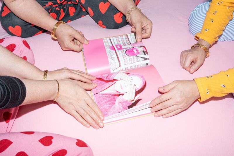 Women in Balat looking at the book