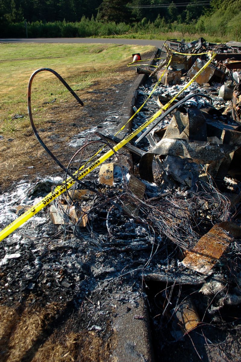 © Erin McMillen Gustafson - Yellow police tape cordoned off the remains, the fire long since subdued.