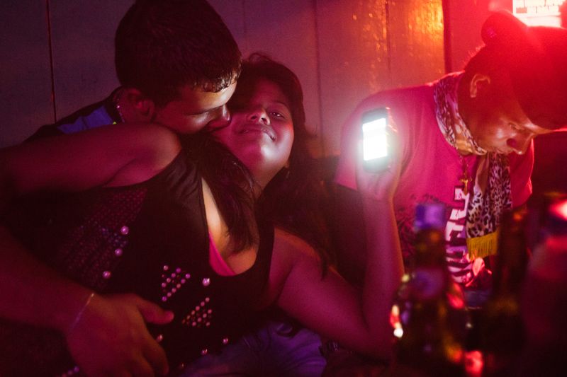 © Misha Vallejo - A couple kisses in a bar. With only around 500 inhabitants, Puerto Nuevo has at least five bars and five churches.