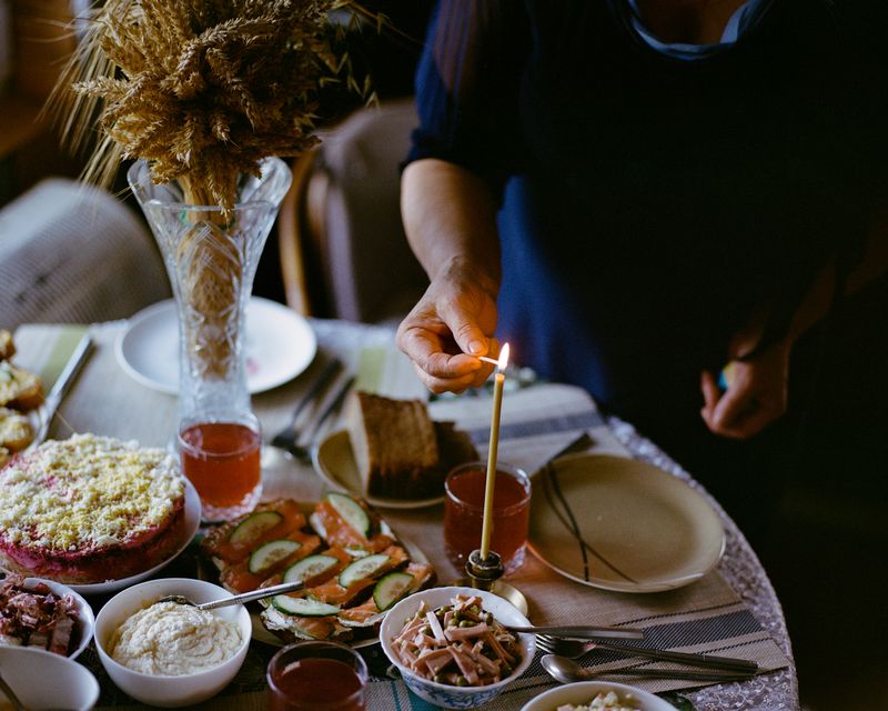 © Anya Tsaruk - My grandmother Maria lights a candle on the Christmas table in the Khmelnytskyi region.