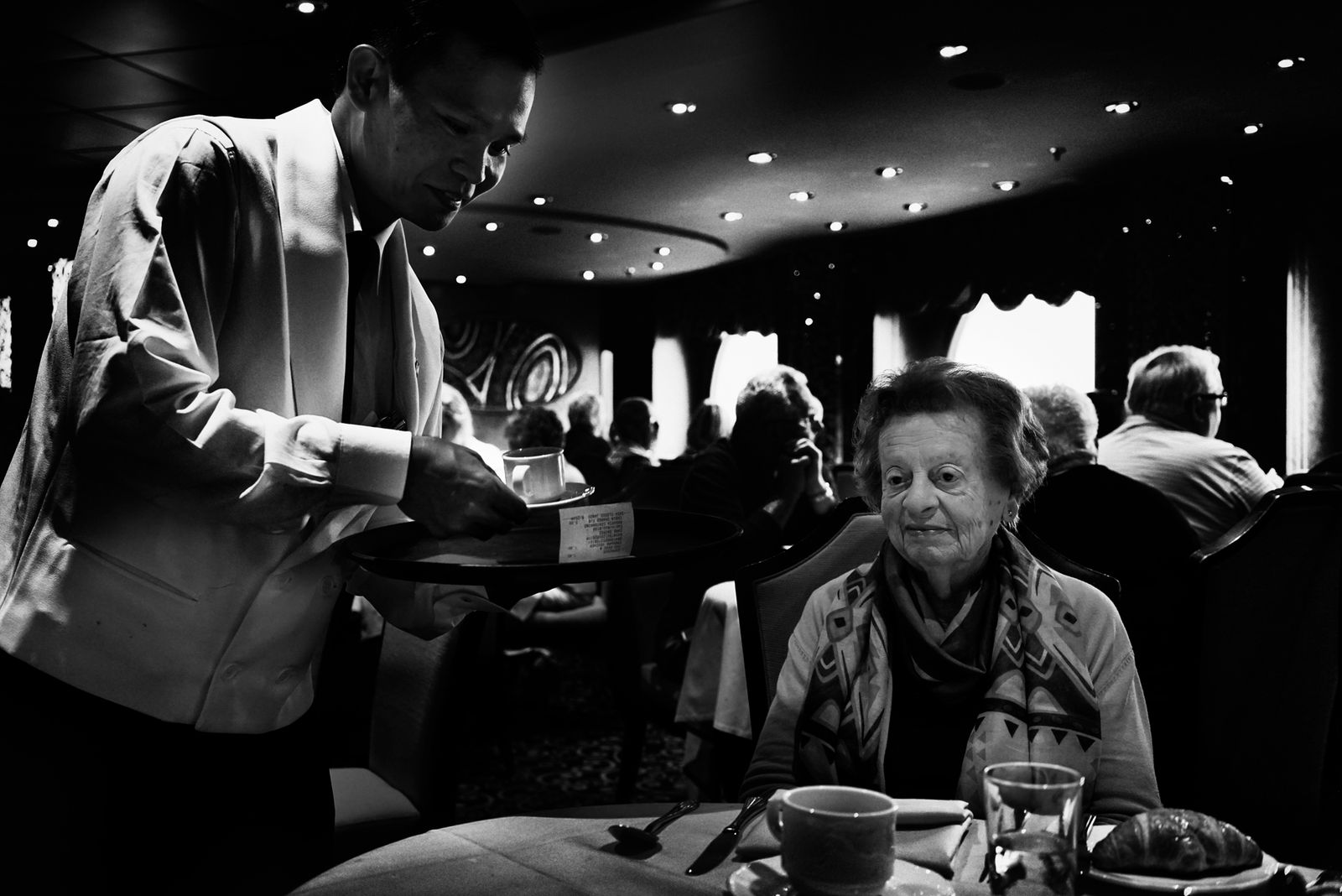 © Simona Bonanno - Old lady having her breakfast In the restaurant. At Sea, 2015