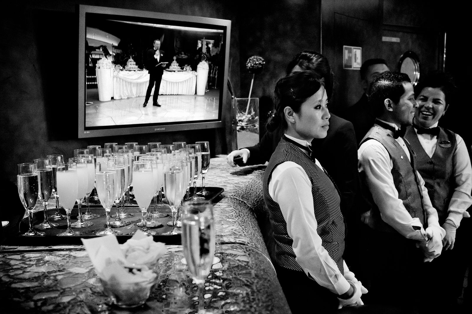 © Simona Bonanno - Waiters listening to the cruise director's speech, waiting for serving the cocktails. At sea 2015.