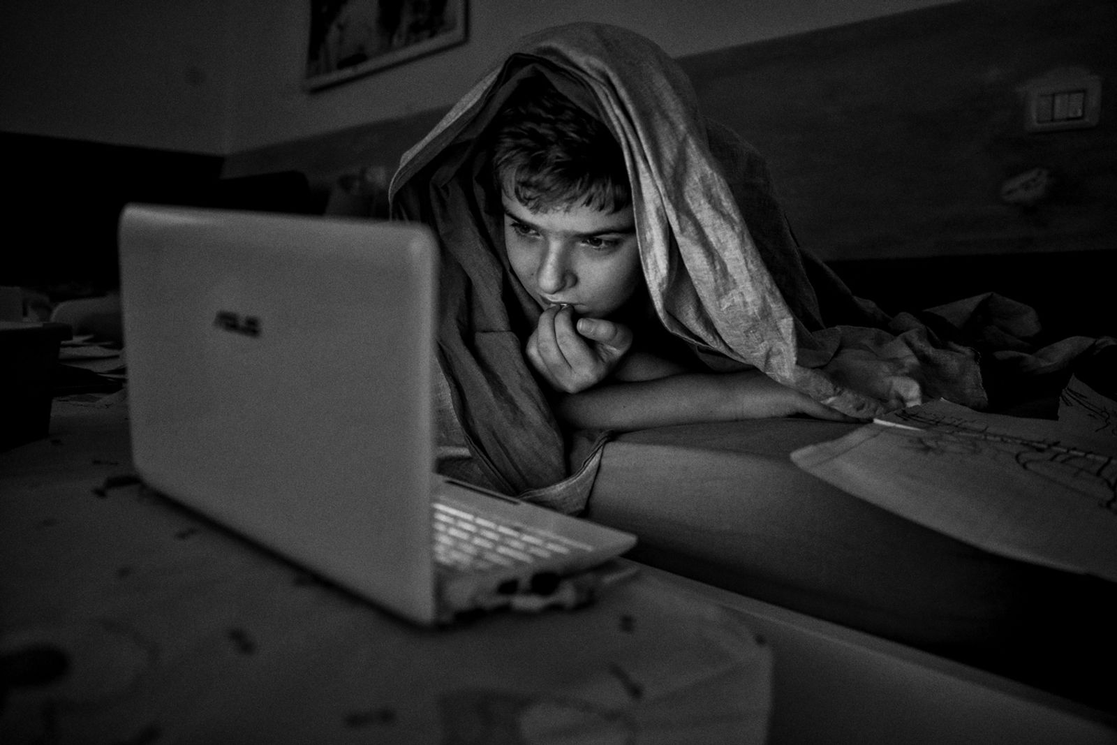 © BARBARA ZANON - Perugia, July 2018: Riccardo (12) watches videos on youtube in his bed before sleeping