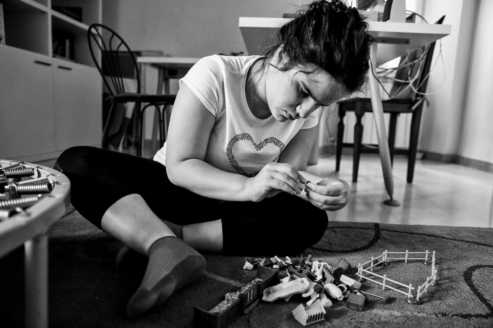 © BARBARA ZANON - Magione, Perugia, Italy - July 2018. Luisa (12) plays with her games at home.