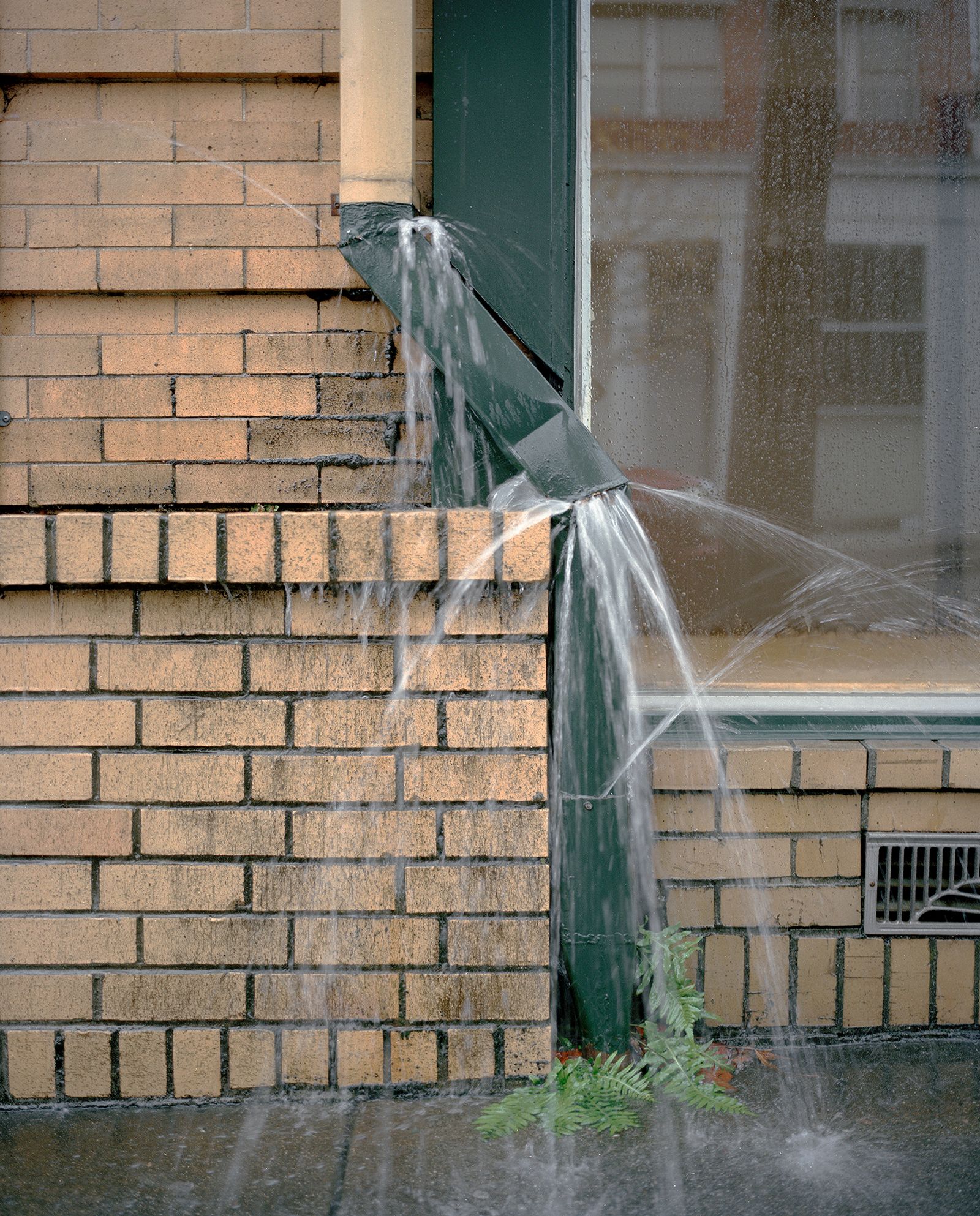 © Justin Maxon - A busted drain spout is seen during a heavy rain storm in Eureka.
