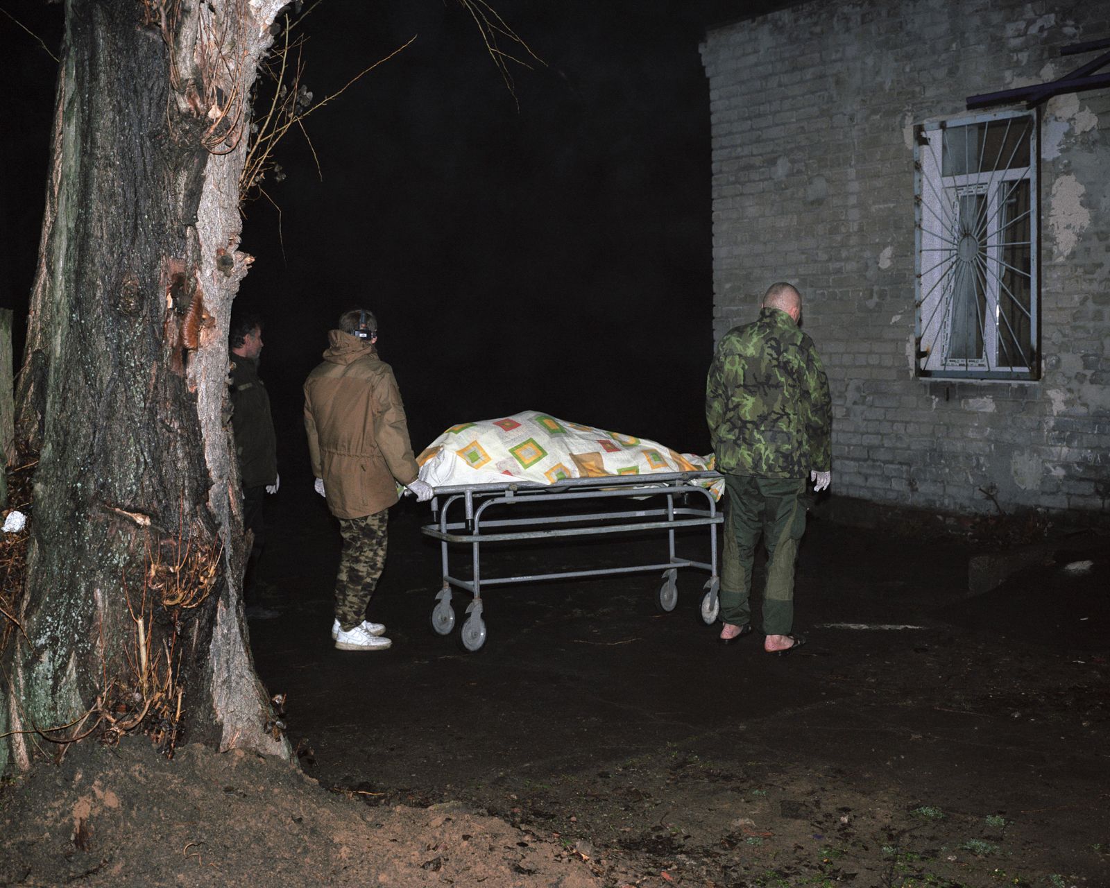 © Jan Jurczak - Vladimir (right) outside a morgue, Avdiivka, Donetsk suburbs, January 2018