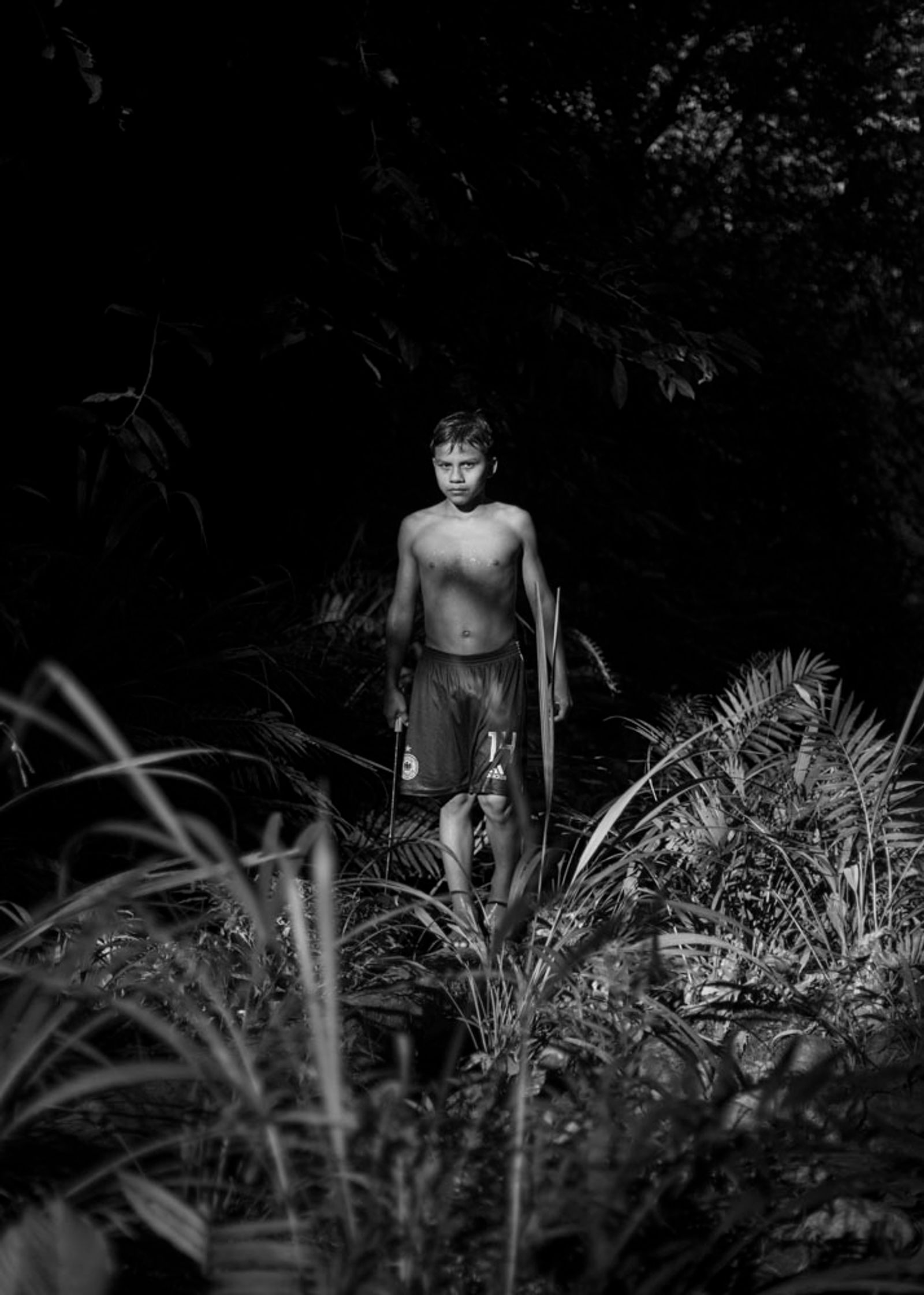 © Daniela Beltran B. - A portrait of Juan Carlos, Naime's son, walking through the river next to their house.