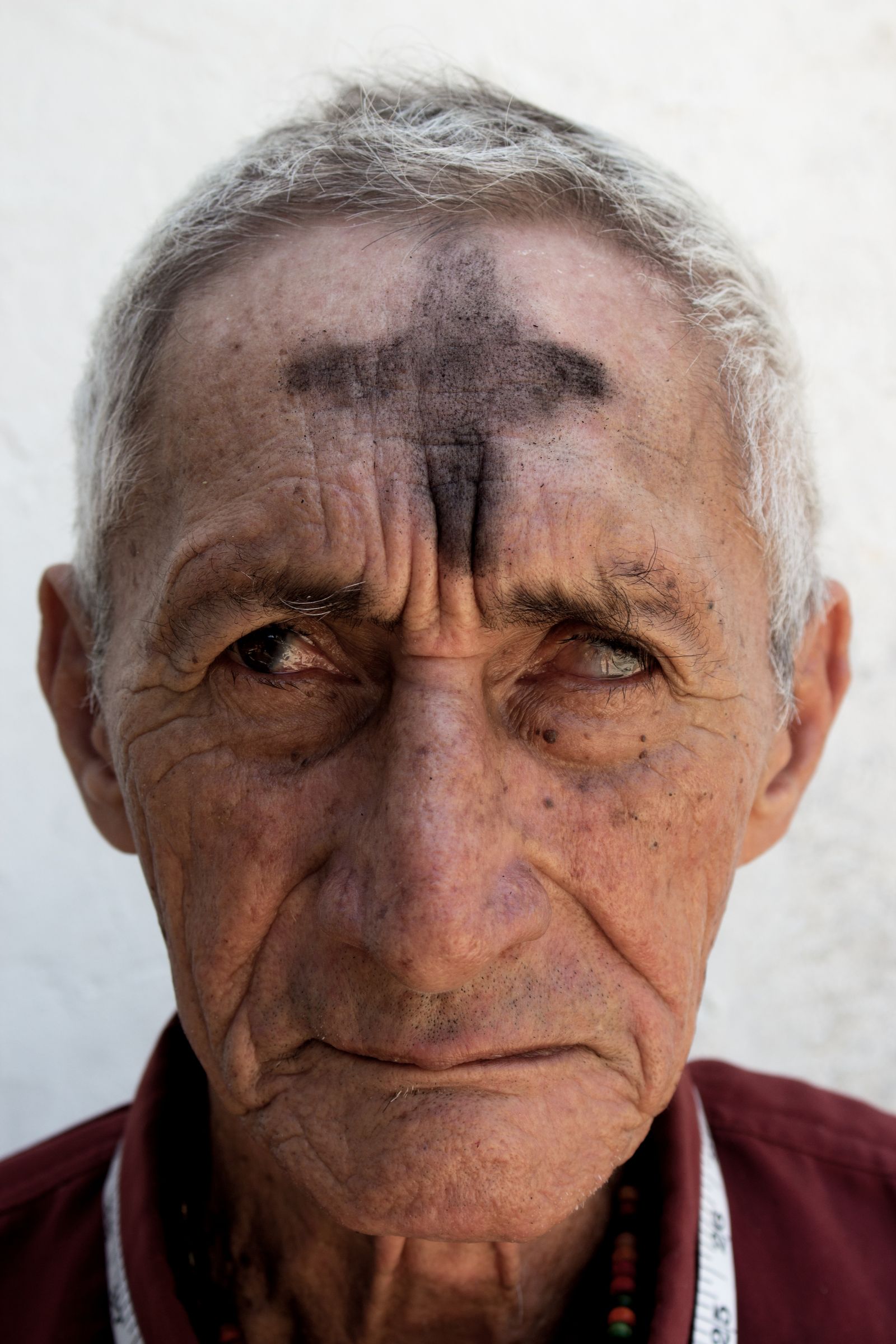 © Luis Cobelo - The cross of death marked on his forehead