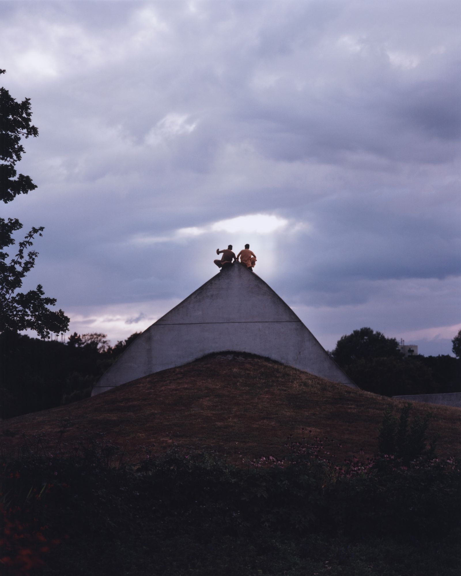 © Alexandre Silberman - Two boys in qamis taking a selfie on top of a concrete pyramid // Georges-Valbon Park- La Courneuve // August 2019