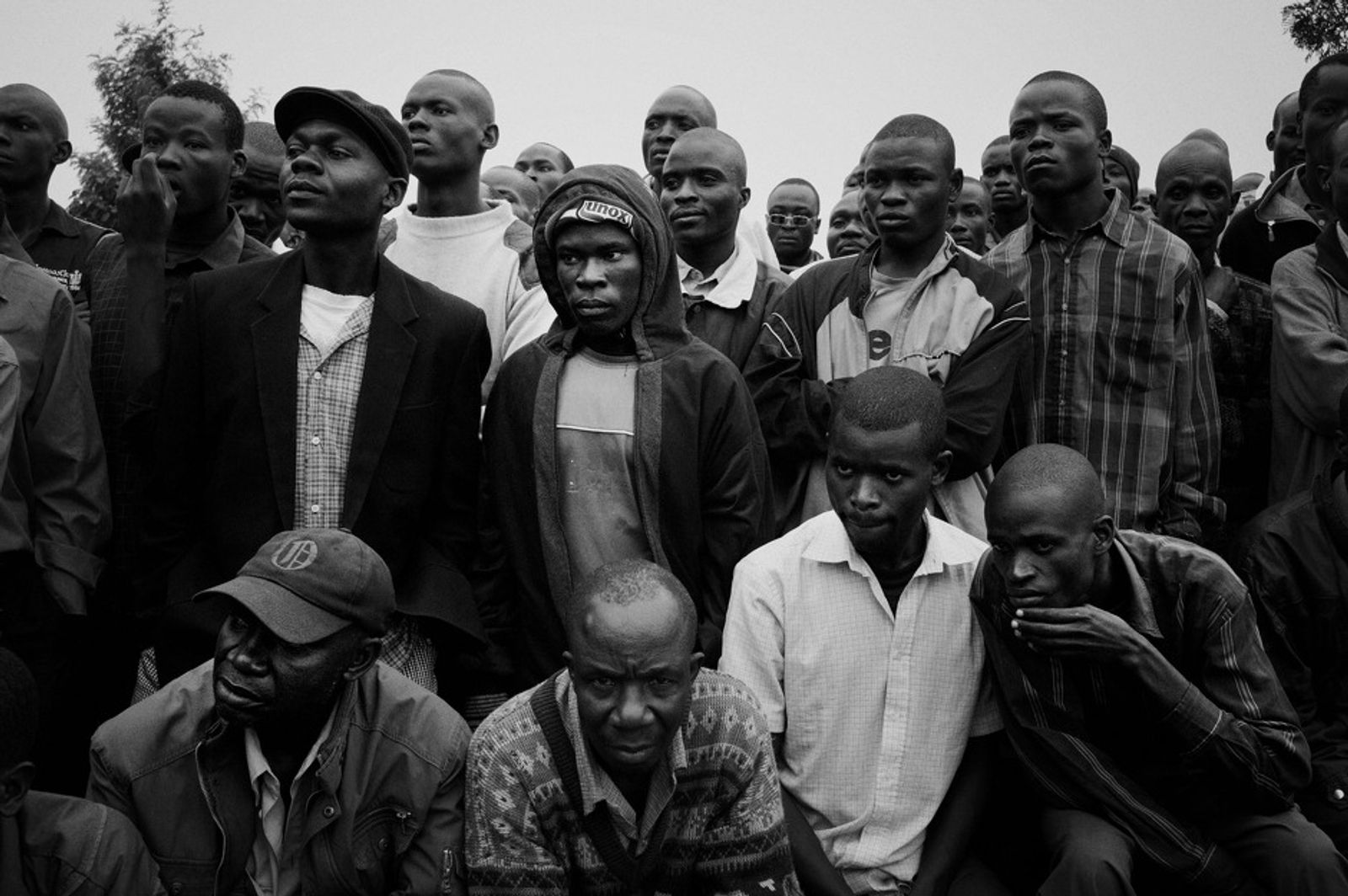 © Bob Miller - A crowd of Luo youth gather to listen to an address at a Kamkunji gathering in Kisumu Ndogo village in Kibera Slum, Nairobi.