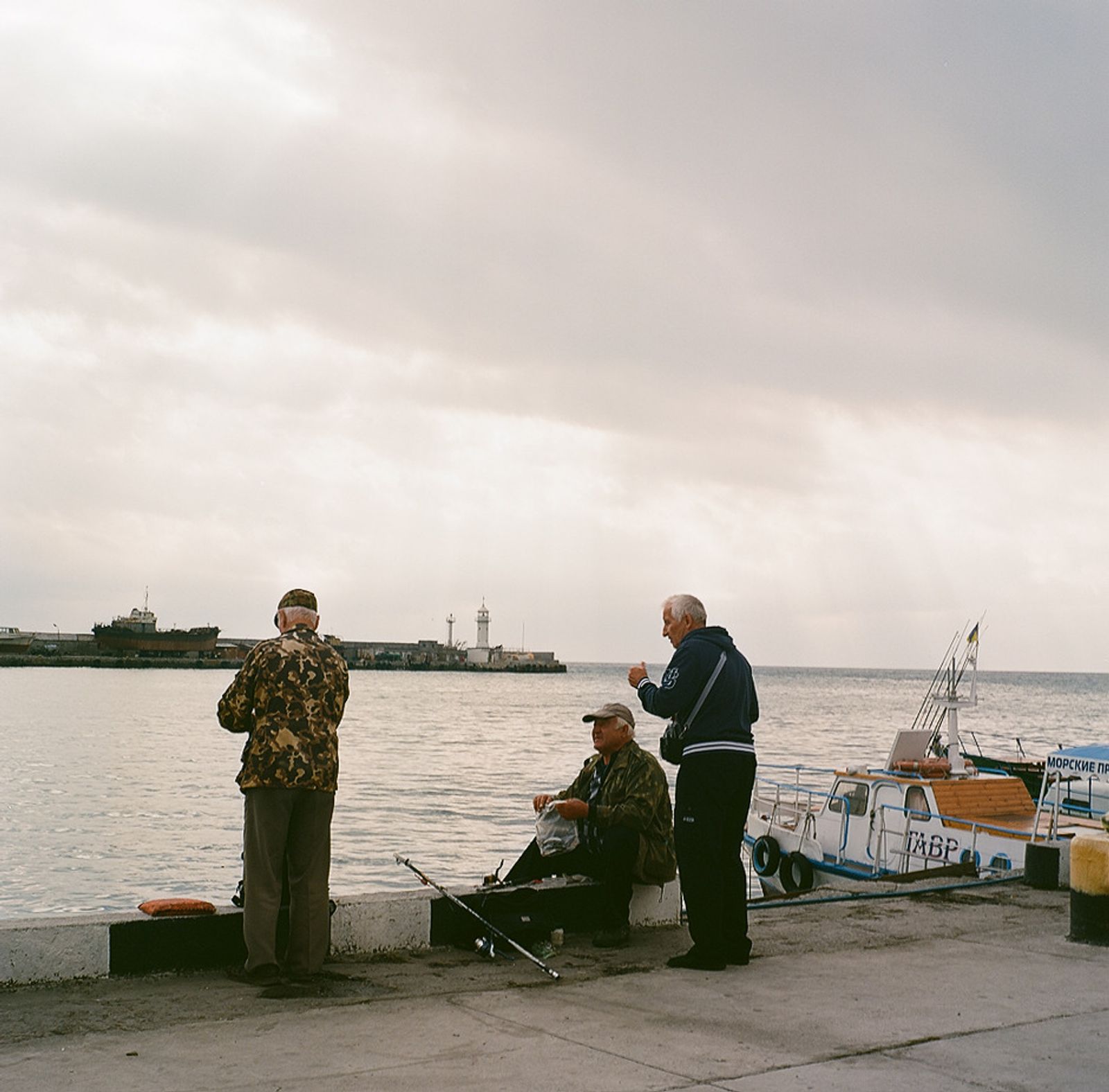 © Natalia Shlyakhovaya - Seafront. The fishers on the quay in Yalta. Yalta, Crimea, Ukraine.