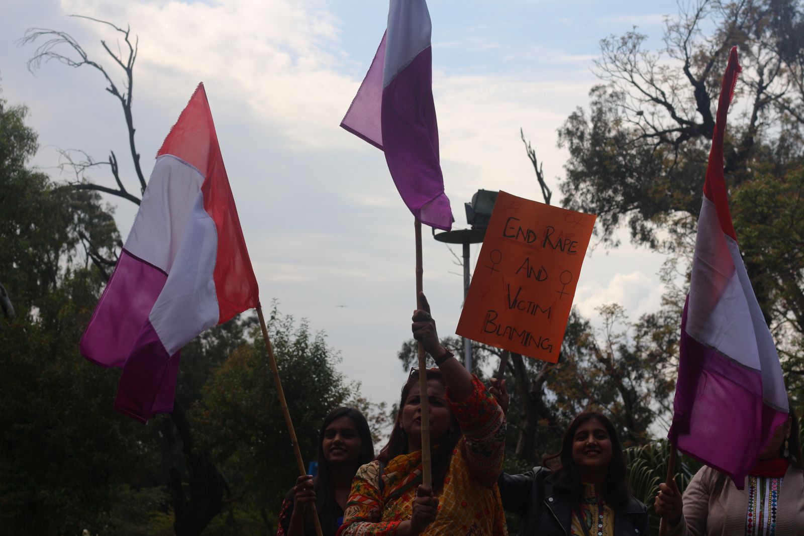 © Maheen Qadri - Comrades of the Women's Democratic Front in Islamabad (2020), waving their party's flag before the march begins.
