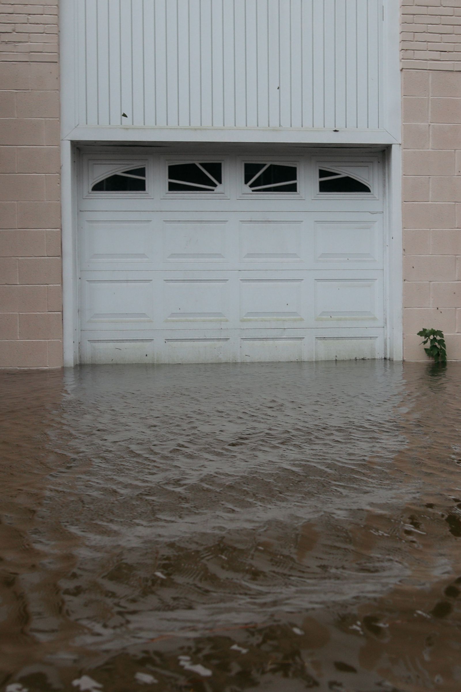 © Angela Ramsey - As the waters rise it seeps into garages and porches throughout the neighborhood.
