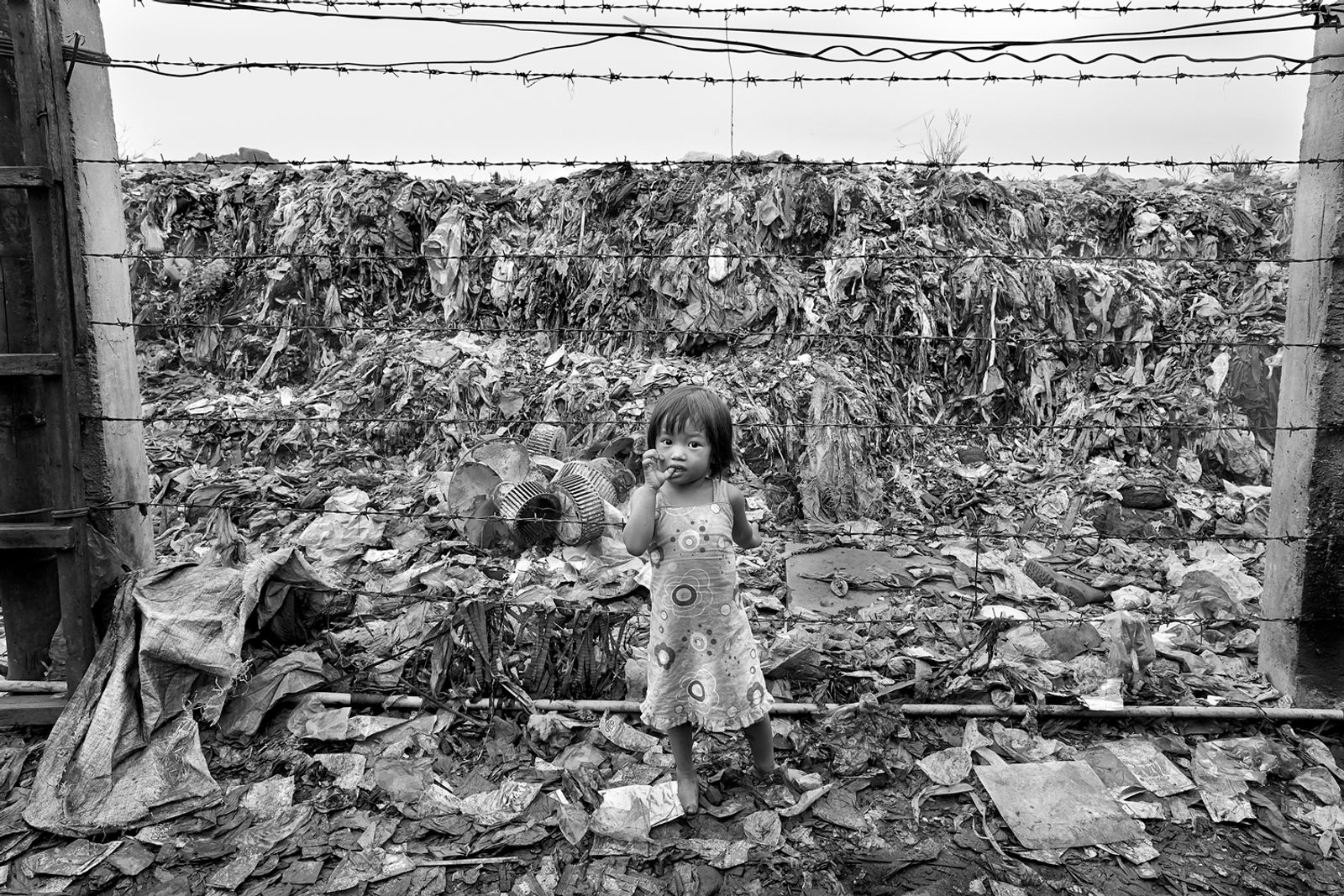 © Larry Louie - A 3 year old girl living and playing at the Smokey Mountain garbage dump in Manila.