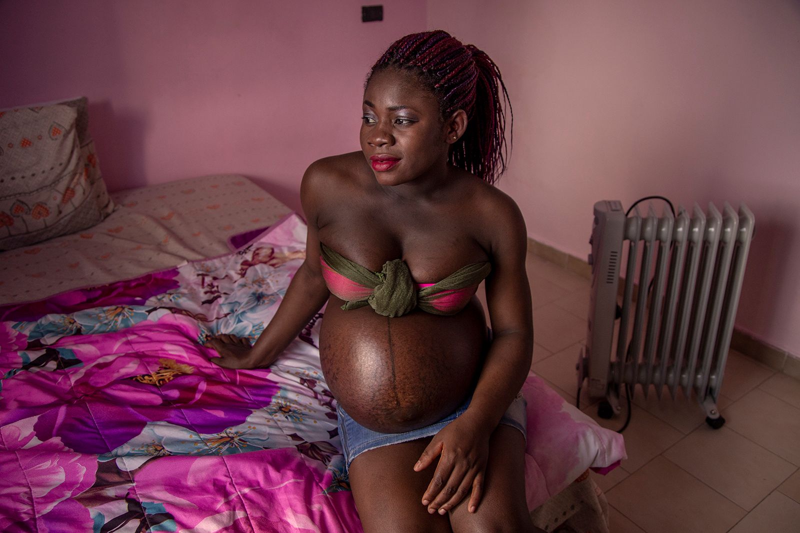 © Alessio Paduano - A pregnant girl is seen in her bedroom in Castelvolturno, Southern Italy on May 27, 2018.