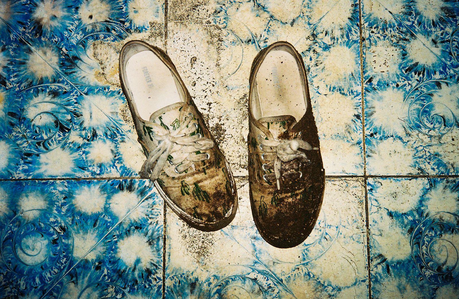 © Lisette Poole González - Muddy shoes after crossing the border into Honduras at night.