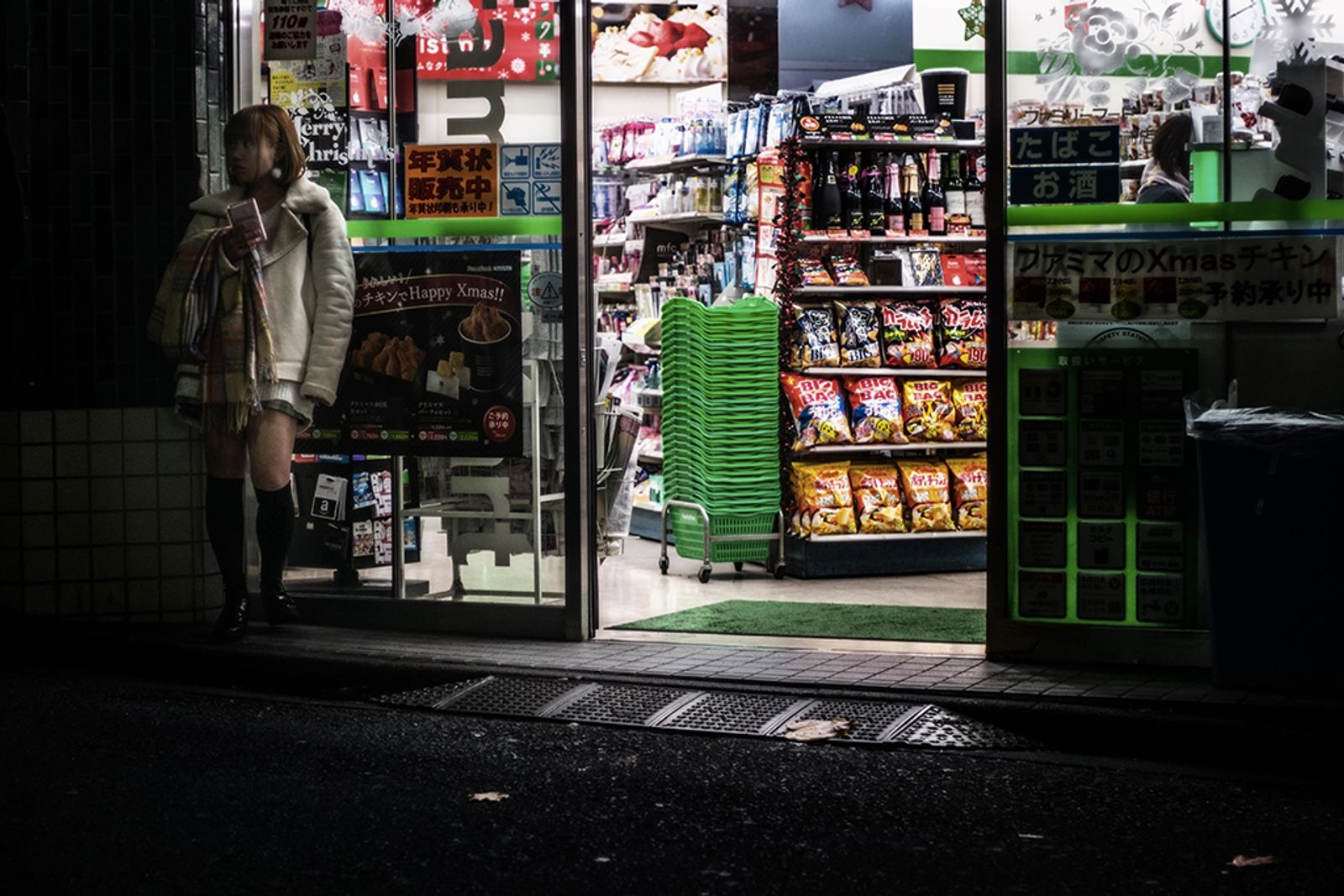 © Isabella Borrelli - A young prostitute waits for a client at the corner of a small grocery store open all night.